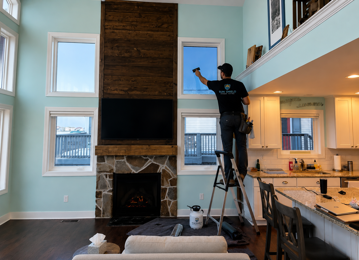 Doctor Tint installer applying window film in a Delaware beach home